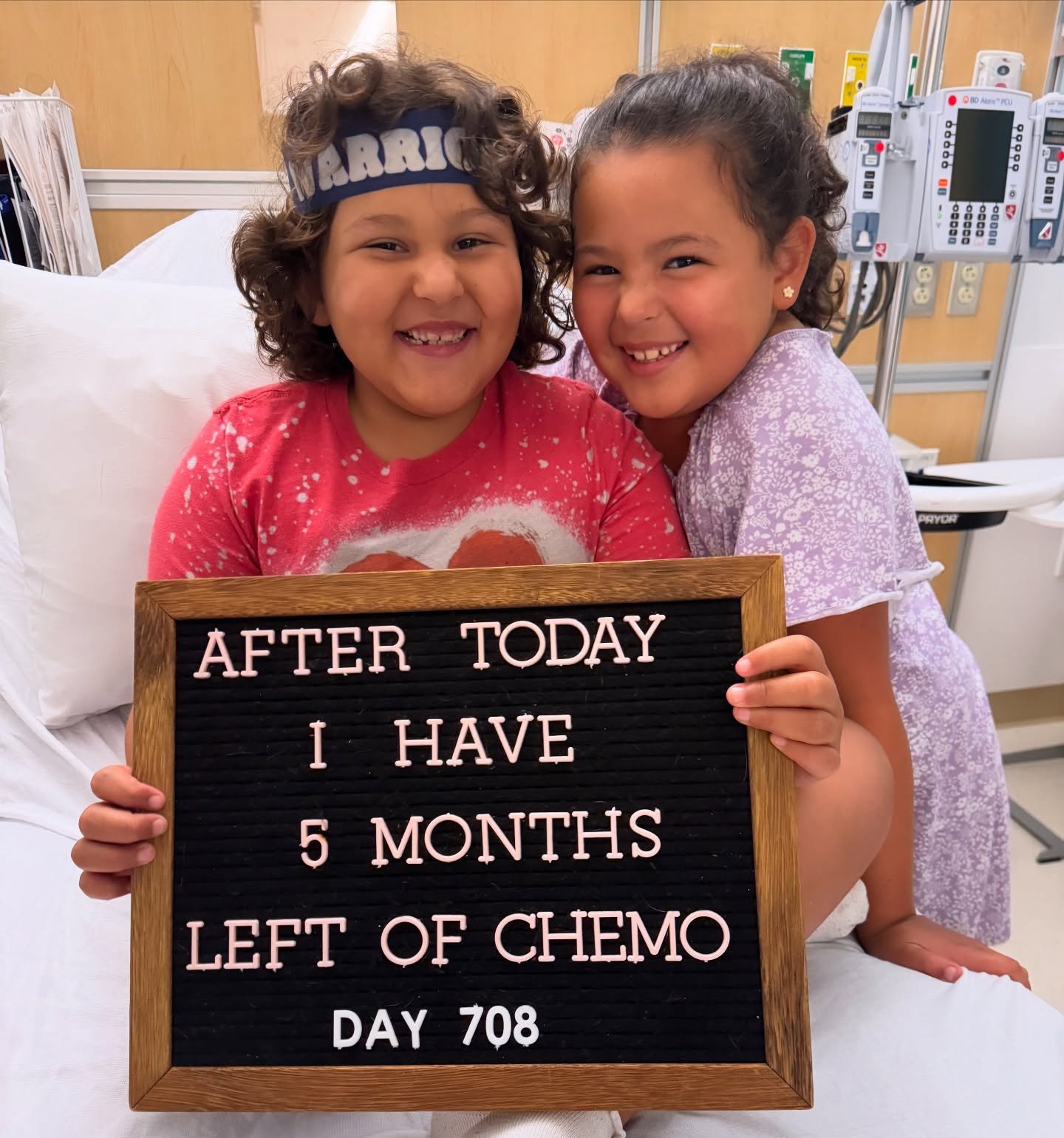 Picture of Rubi with a sign that says: After today I have 5 months left of chemo. 